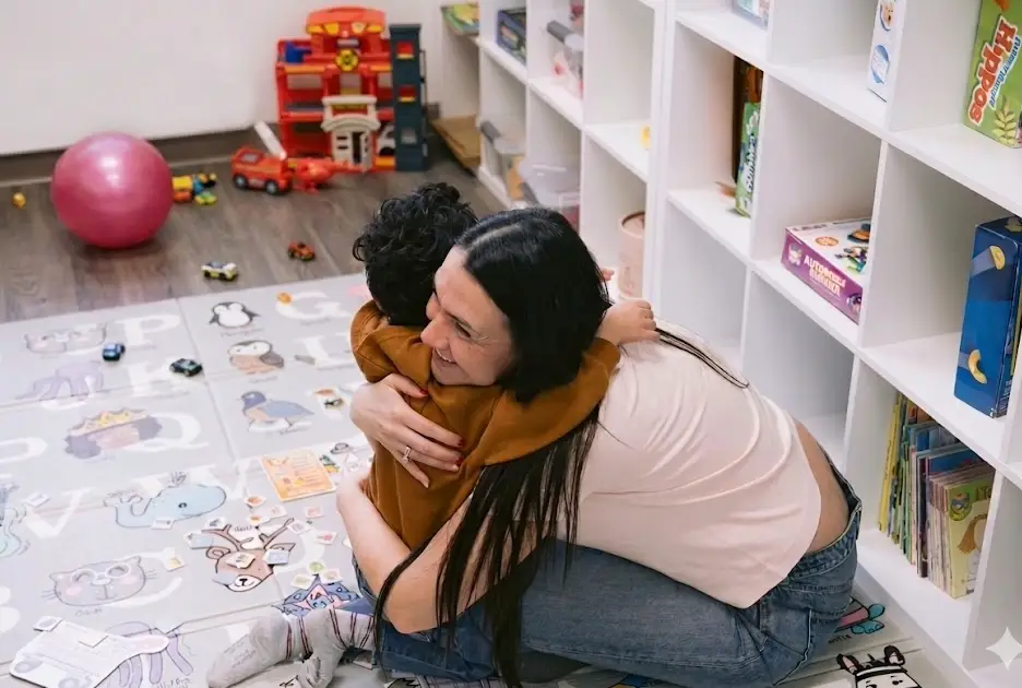 Child hugging the therapist