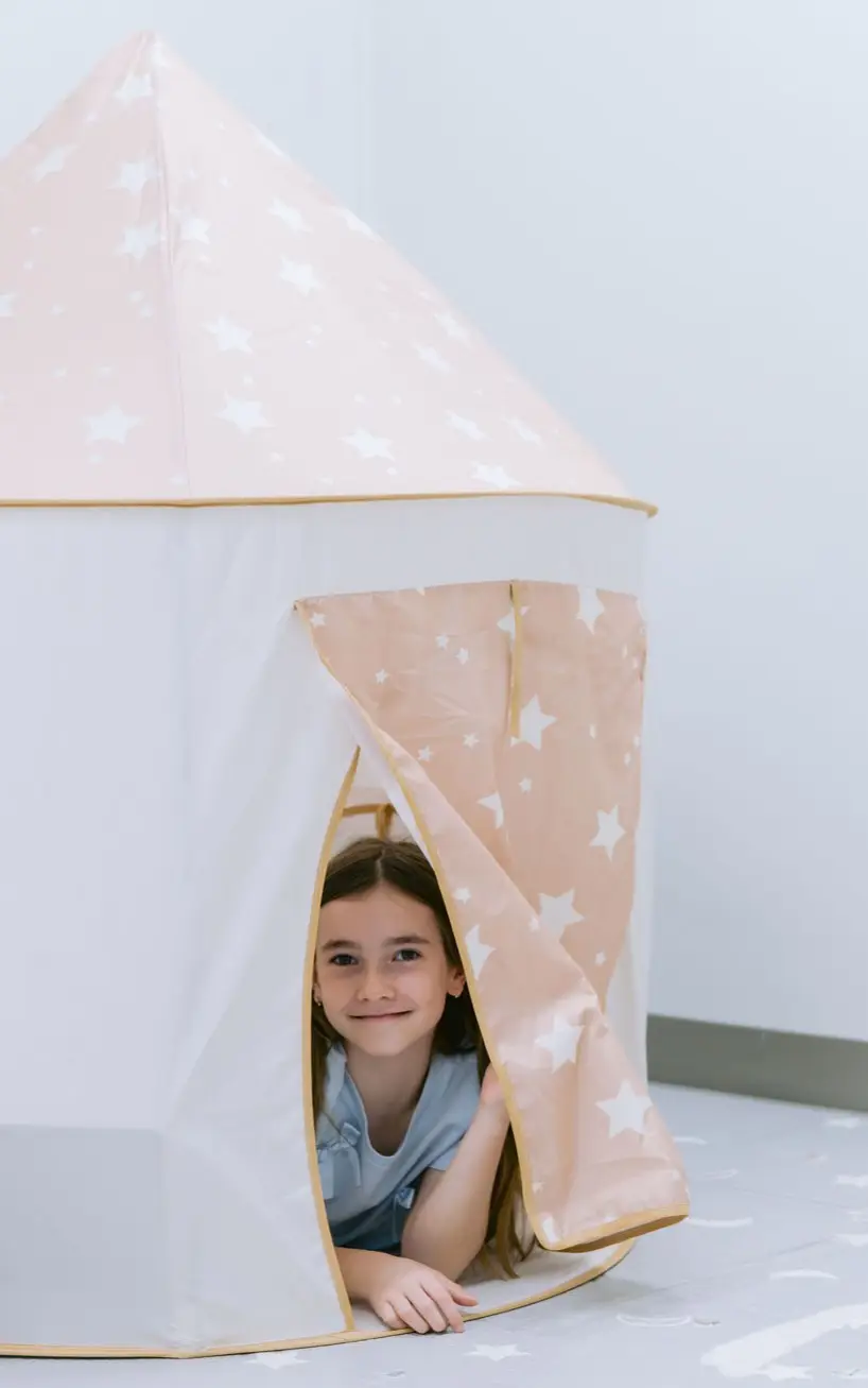 Child playing in a tent